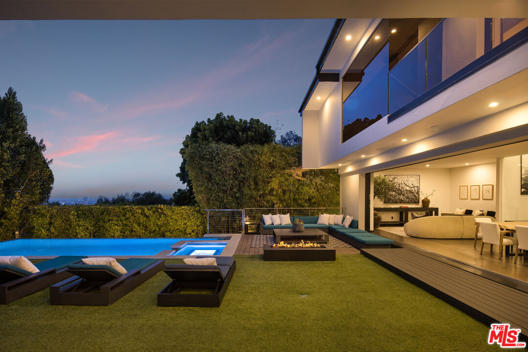 1516 North Kings Road Los Angeles, CA 90069 - Photo 36 of 45 a swimming pool with lawn chairs and painted walls