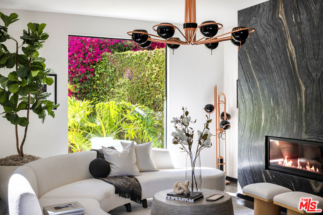 1516 North Kings Road Los Angeles, CA 90069 - Photo 4 of 45 a living room with furniture and a flat screen tv