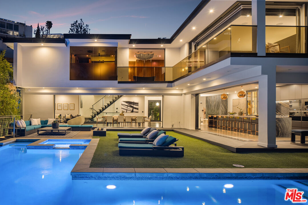 1516 North Kings Road Los Angeles, CA 90069 - Photo 43 of 45 a room with lots of potted plants and large trees