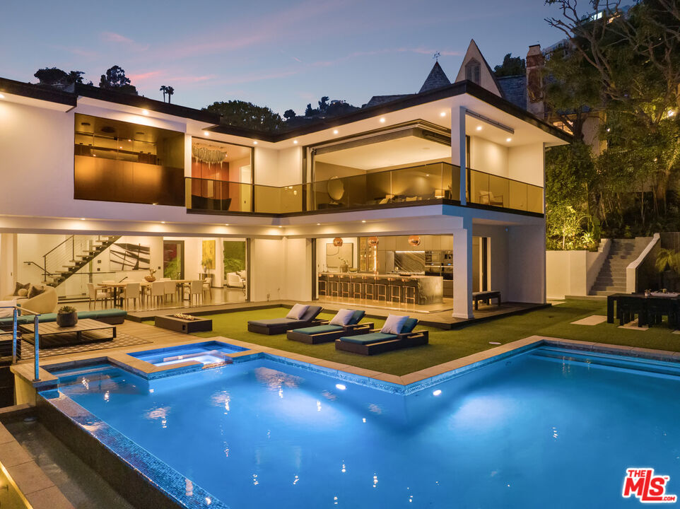 1516 North Kings Road Los Angeles, CA 90069 - Photo 45 of 45 a view of a swimming pool with chairs in front of building