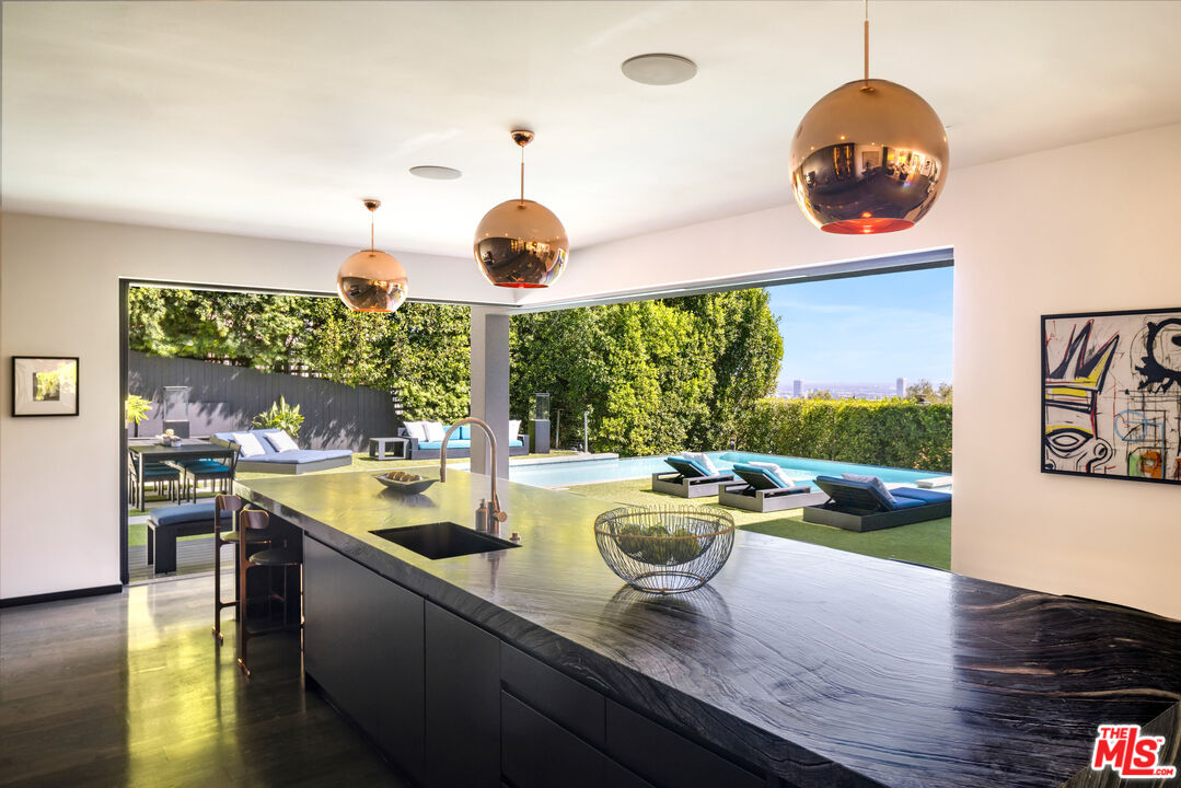 1516 North Kings Road Los Angeles, CA 90069 - Photo 7 of 45 a view of a dining room and kitchen with a large window