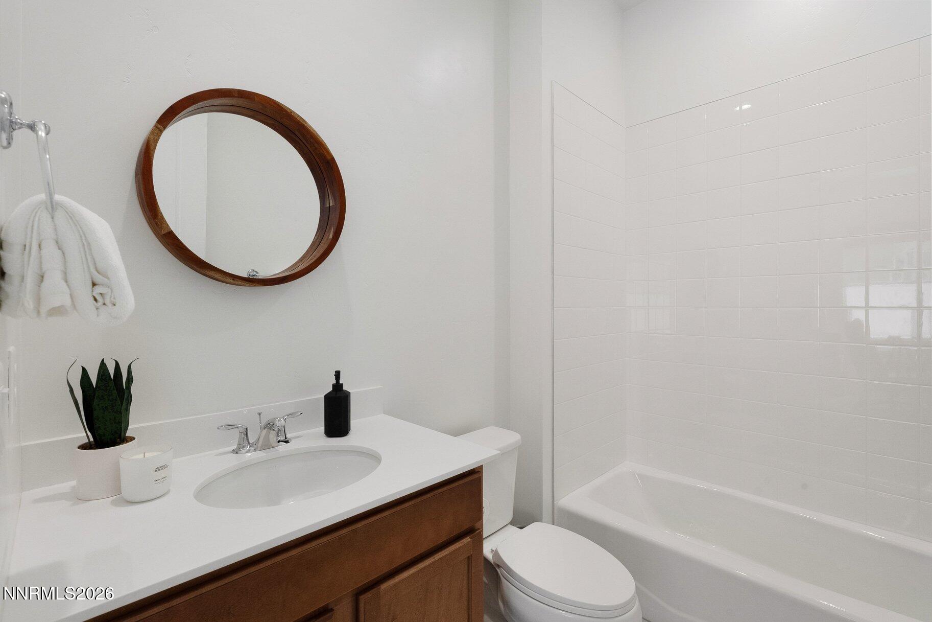 6110 South Pleasant Oak Trail Reno, NV 89511 - Photo 26 of 66 a bathroom with a sink a toilet and a bathtub