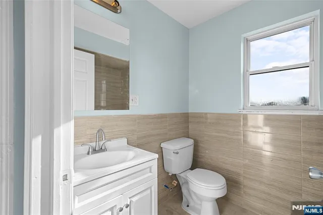 a bathroom with a toilet sink and a mirror