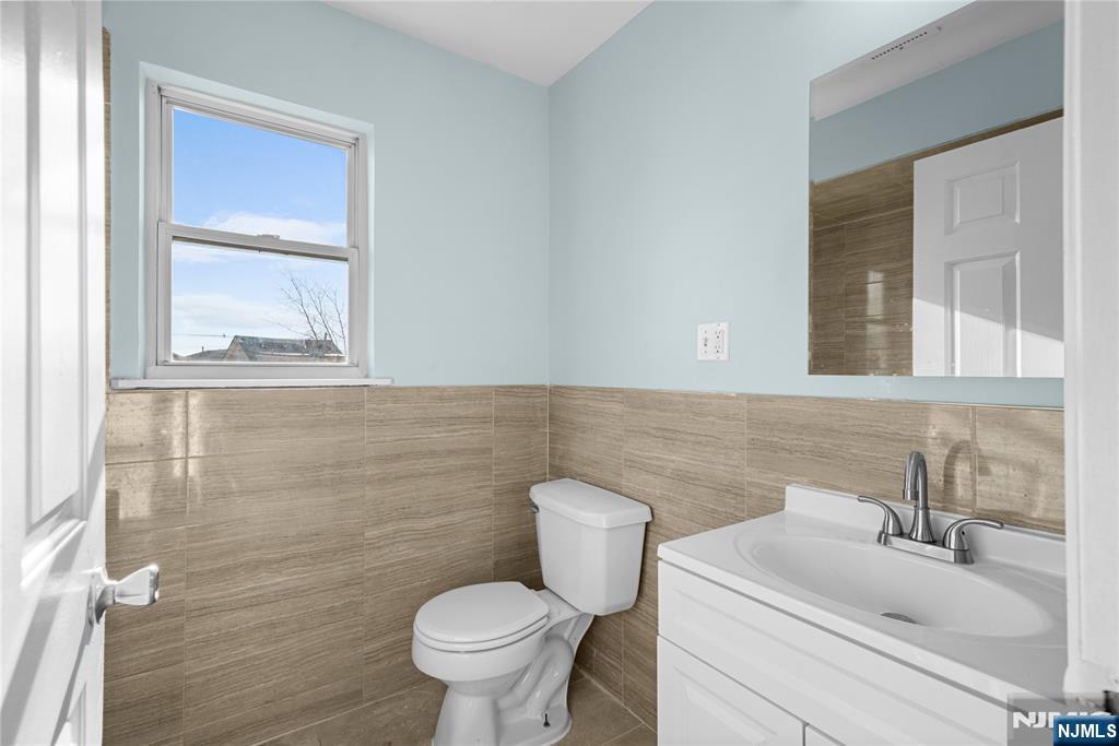 219-221 Clinton Place Newark, NJ 07112 - Photo 19 of 21 a bathroom with a sink toilet and mirror