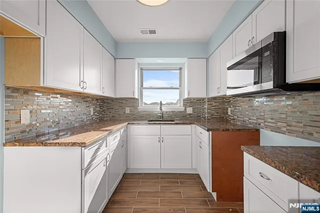 a kitchen that has a sink and a stove in it