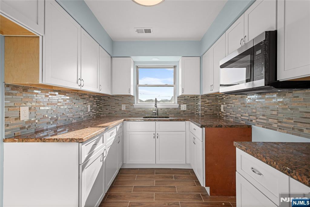 219-221 Clinton Place Newark, NJ 07112 - Photo 3 of 21 a kitchen that has a sink and a stove in it