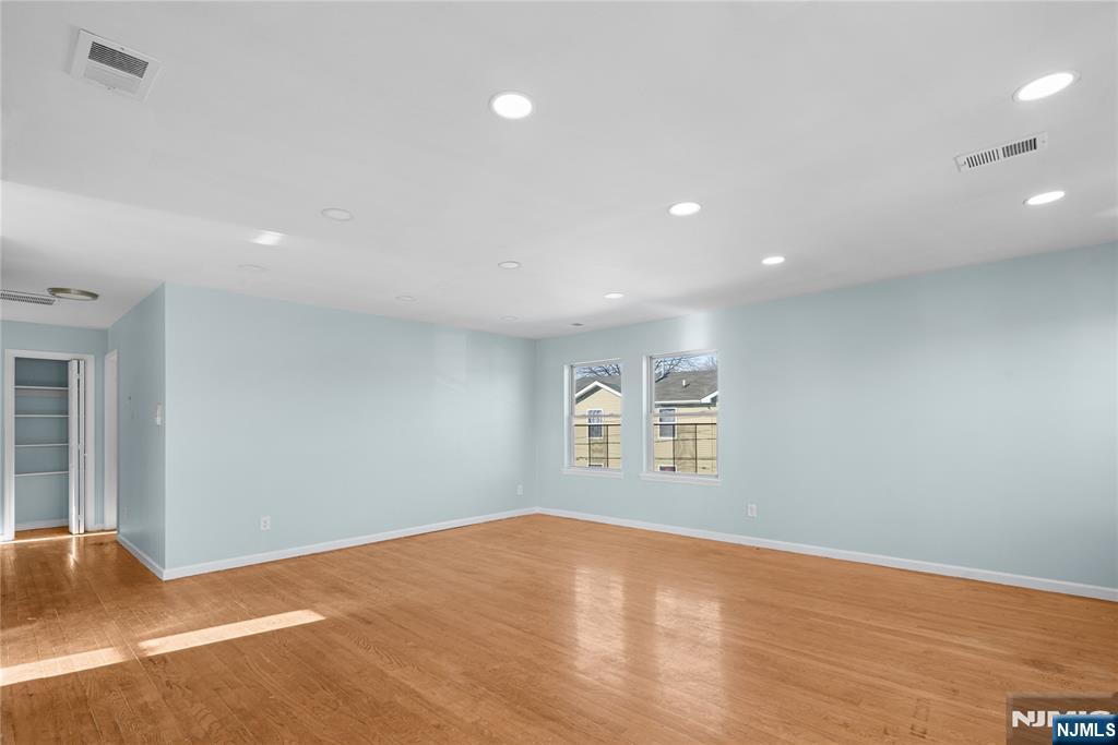 219-221 Clinton Place Newark, NJ 07112 - Photo 4 of 21 a view of empty room with wooden floor and fan