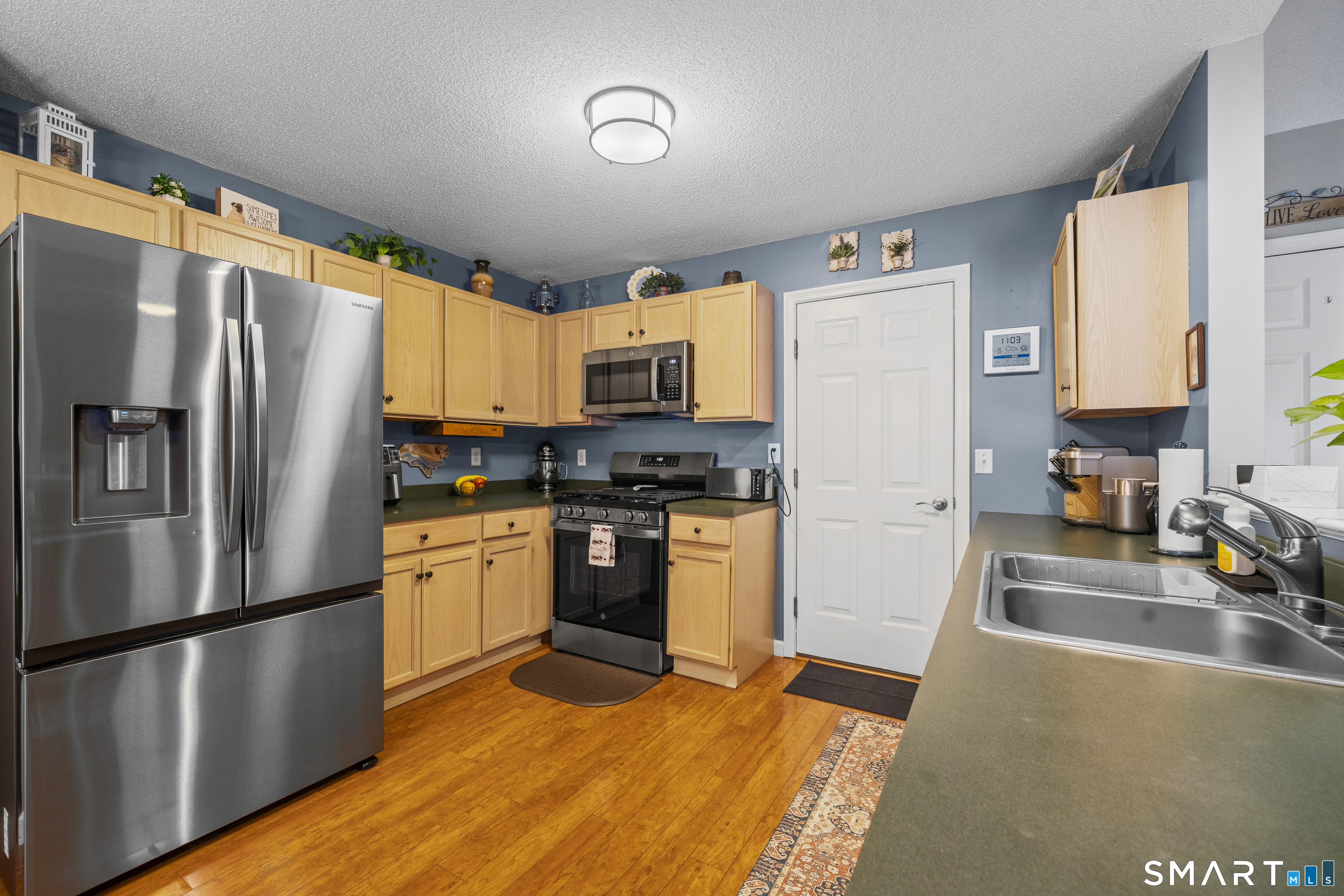 7 Heather Lane, Unit 7 Suffield, CT 06078 - Photo 10 of 34 a kitchen with stainless steel appliances a refrigerator sink and microwave