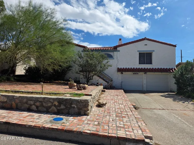 a view of a house with swimming pool and sitting area