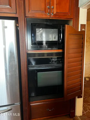 a stove top oven sitting inside of a kitchen
