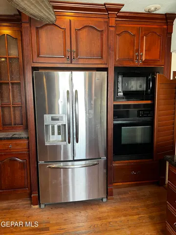 a kitchen with wooden cabinets and a sink