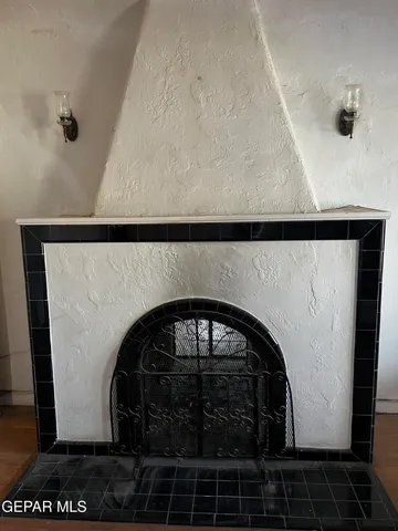 a view of a livingroom with a fireplace and window