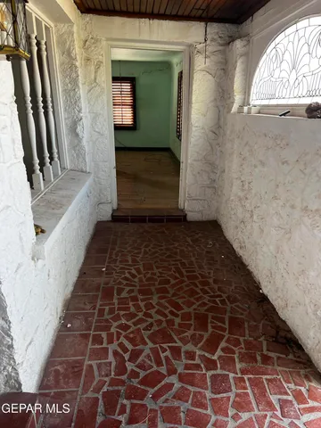 a view of a hallway with wooden floor and closet