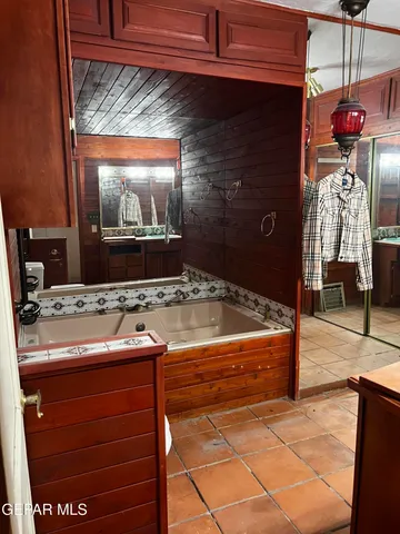 a bathroom with a sink a mirror and bathtub