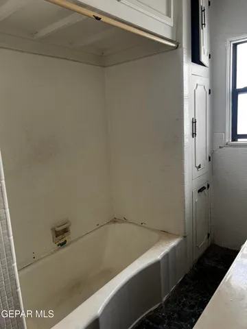 a bathroom with a tub and sink