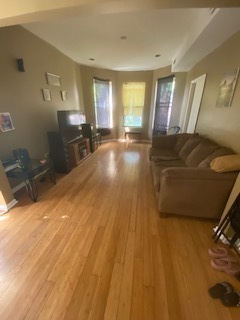 6507 South Rhodes Avenue Chicago, IL 60637 - Photo 3 of 9 a living room with a couch and large windows