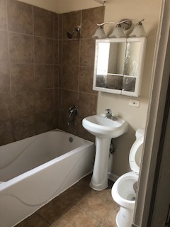 6507 South Rhodes Avenue Chicago, IL 60637 - Photo 6 of 9 a bathroom with a sink toilet and shower