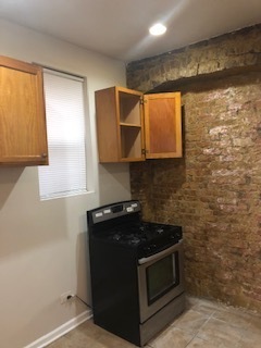 6507 South Rhodes Avenue Chicago, IL 60637 - Photo 8 of 9 a kitchen with granite countertop cabinets and a stove
