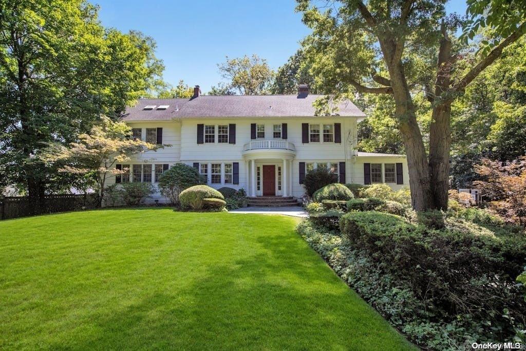 31 The Intervale Roslyn, NY 11576 - Photo 1 of 1 a front view of a house with garden