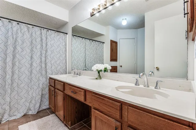 a bathroom with a double vanity sink and a mirror