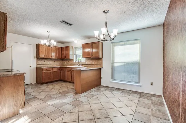 a kitchen with stainless steel appliances a sink stove and refrigerator