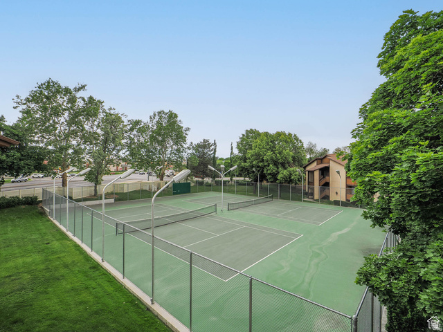 6852 Countrywoods Circle, Unit 5D Midvale, UT 84047 - Photo 40 of 50 Two tennis courts with a hard-surface finish and perimeter fencing