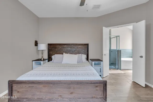 a bedroom with a bed and a mirror