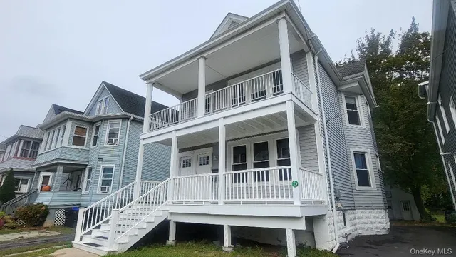 a front view of a house with a deck