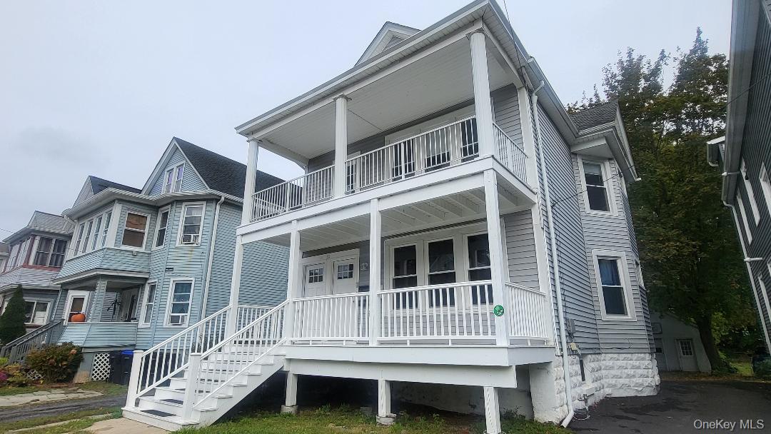 a front view of a house with a deck