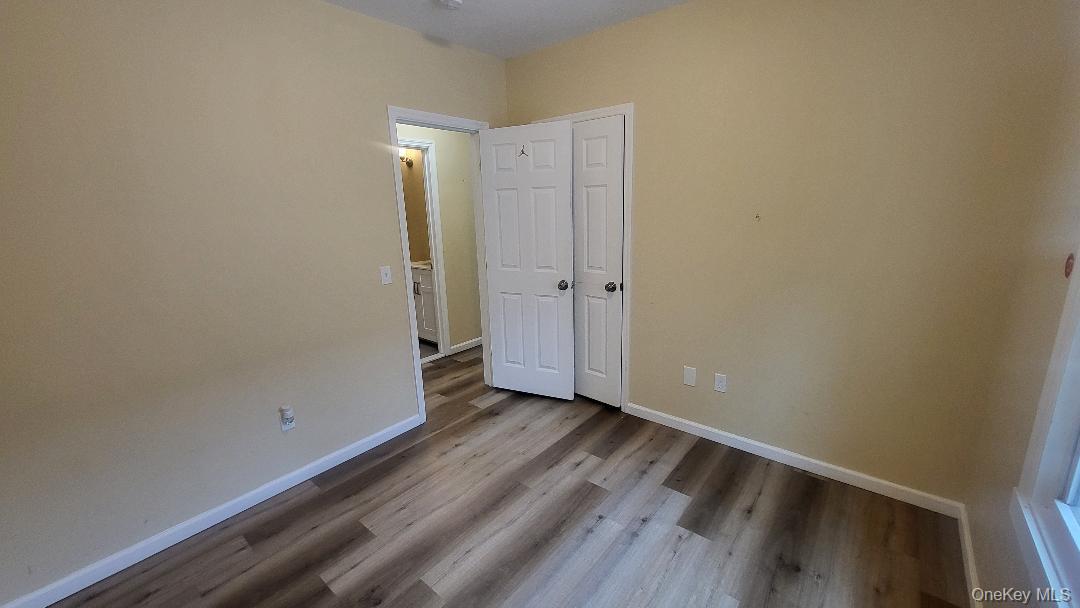 19 Hoffman Avenue, Unit 2 Poughkeepsie, NY 12603 - Photo 16 of 21 a view of an empty room with wooden floor and a window