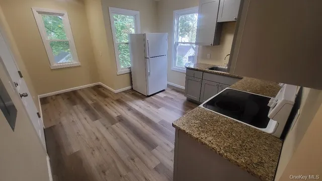 a kitchen with wooden floor and window