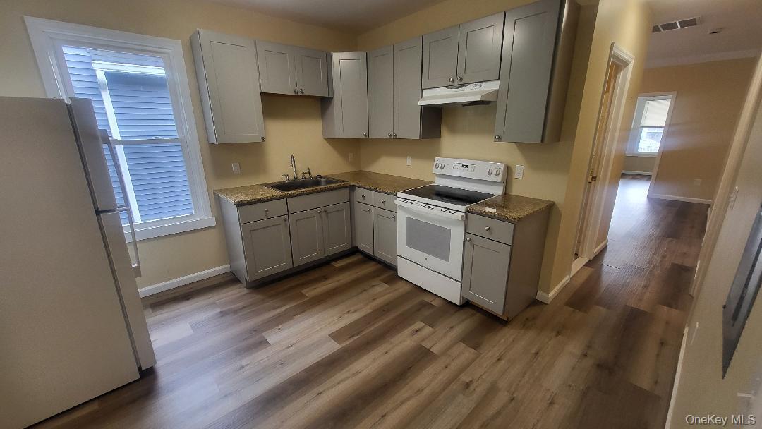 19 Hoffman Avenue, Unit 2 Poughkeepsie, NY 12603 - Photo 6 of 21 a kitchen with stainless steel appliances granite countertop a stove and a refrigerator