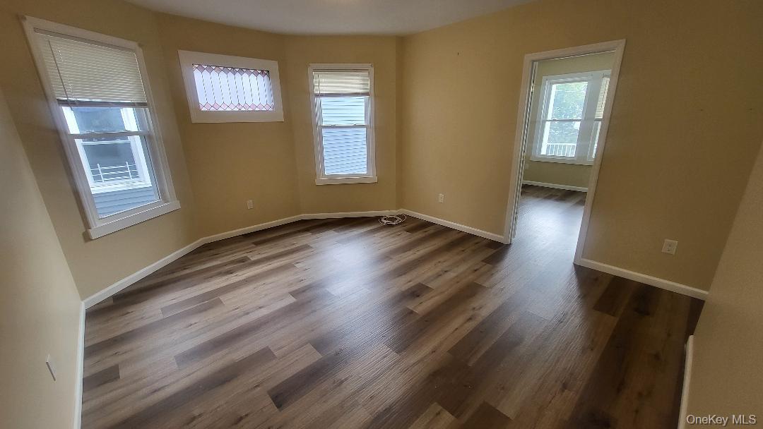 19 Hoffman Avenue, Unit 2 Poughkeepsie, NY 12603 - Photo 9 of 21 a view of an empty room with wooden floor and a window