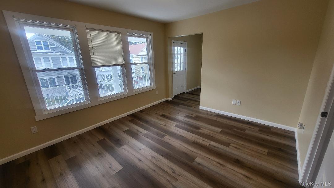19 Hoffman Avenue, Unit 2 Poughkeepsie, NY 12603 - Photo 10 of 21 a view of an empty room with wooden floor and a window