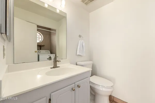 a bathroom with a sink a toilet and a mirror