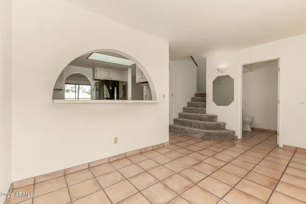 a view of a room with entryway wooden floor and windows