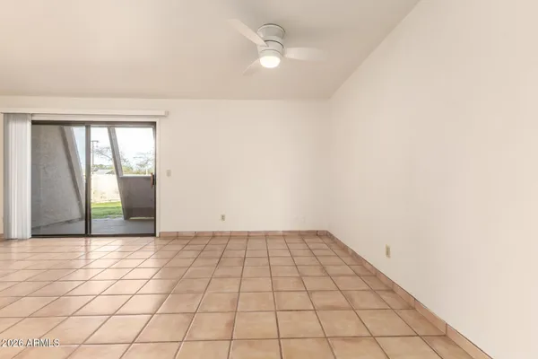an empty room with white walls and tiles
