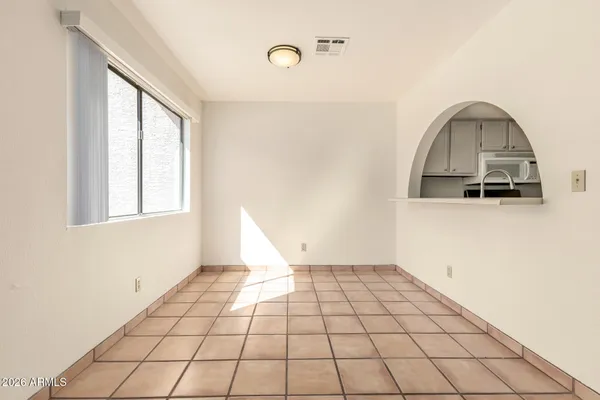 a view of a livingroom with wooden floor and a window