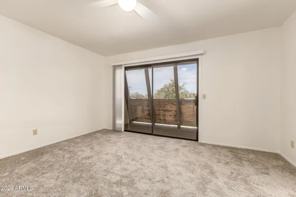 an empty room with wooden floor and sliding door