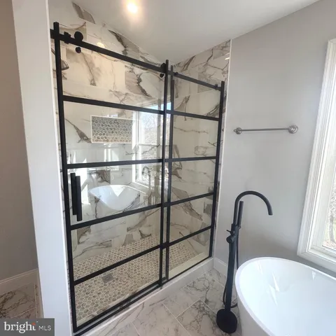 a view of an empty room and wooden floor