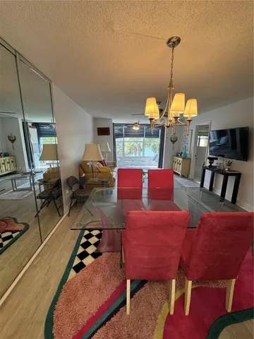 a living room with furniture a chandelier and a table