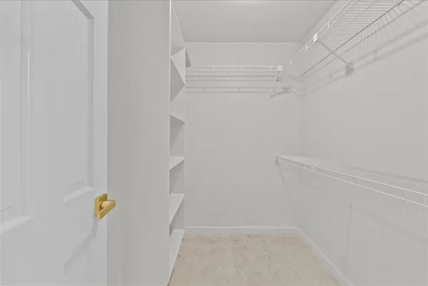 an empty room with windows and ceiling fan view