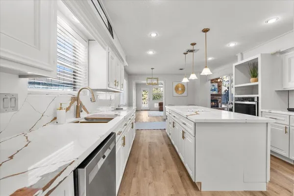 a kitchen with a sink cabinets and window
