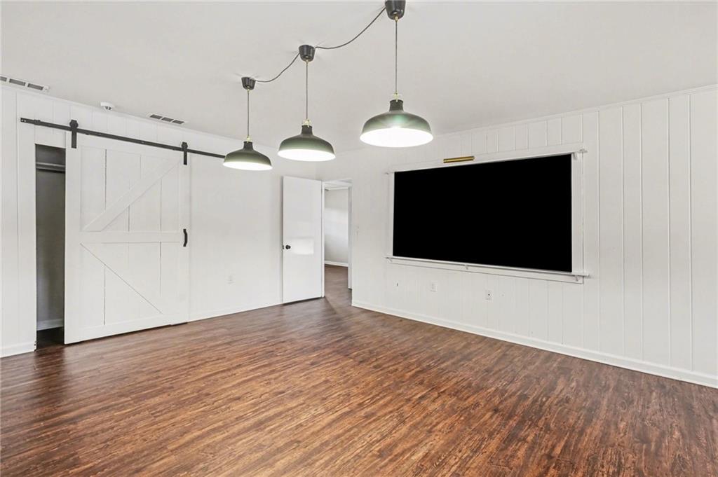 4139 Rebecca Street Southwest Covington, GA 30014 - Photo 11 of 33 a view of an empty room with wooden floor and a ceiling fan