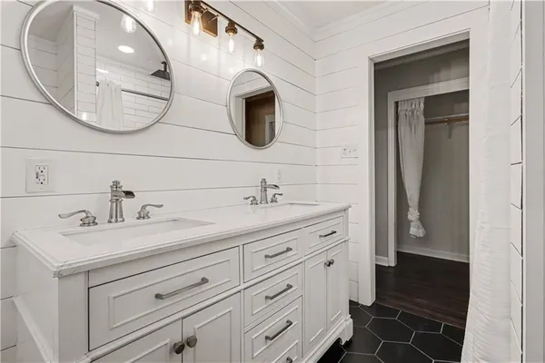a spacious bathroom with a double vanity sink and a mirror