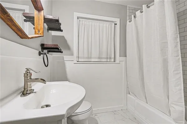 a bathroom with a sink a mirror and a shower