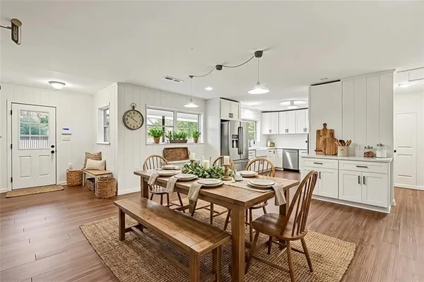 a view of a dining room with furniture window and wooden floor