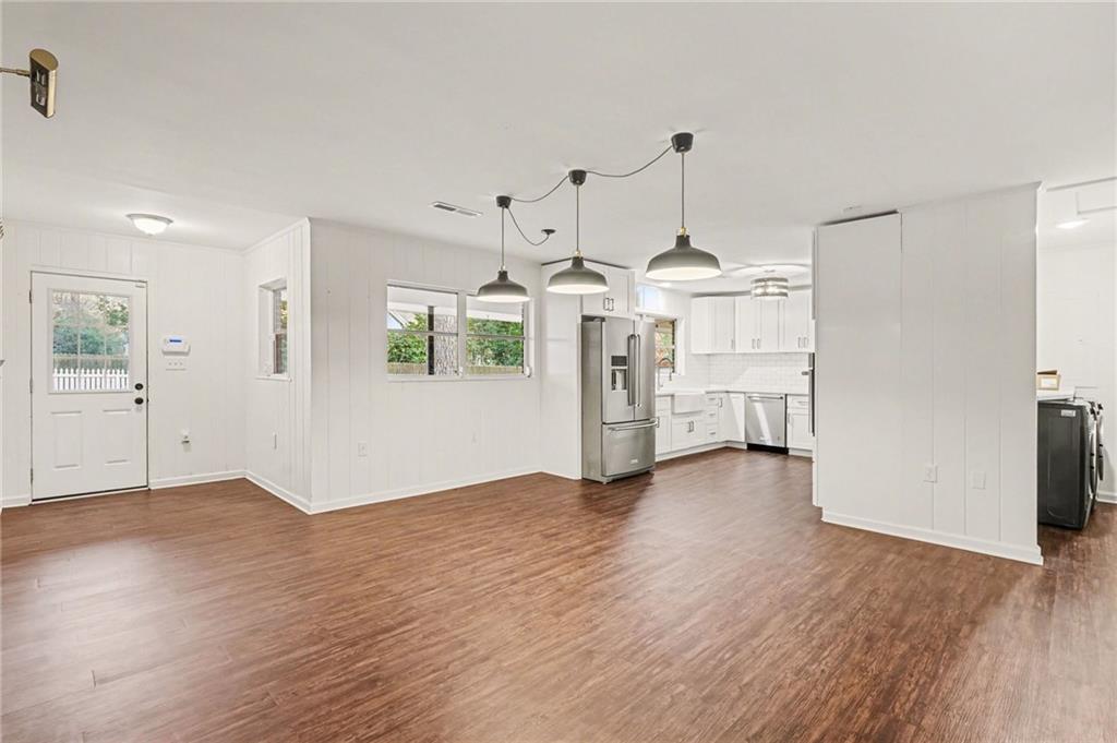 4139 Rebecca Street Southwest Covington, GA 30014 - Photo 8 of 33 a view of a kitchen with refrigerator and an empty room