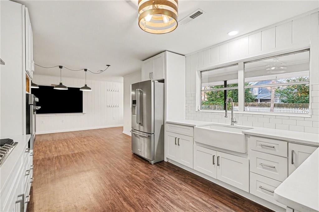 4139 Rebecca Street Southwest Covington, GA 30014 - Photo 9 of 33 a kitchen with cabinets and wooden floor