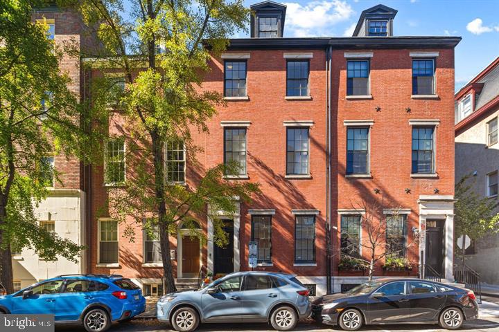 a front view of a residential apartment building with a yard